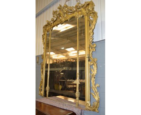 A 19th Century Chippendale style gilt console table and mirror, the three panel glass plate below a cornucopia style pediment