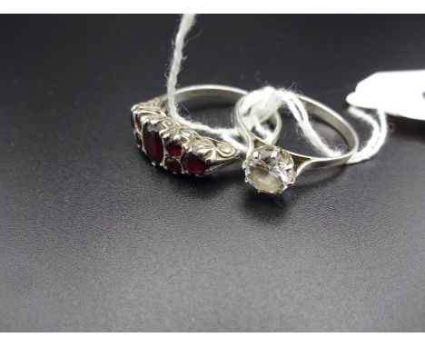 ONE SILVER AND RED STONE RING (PARTIALLY WORN MARKS) PLUS ONE POSSIBLY SILVER RING WITH COMPLETELY WORN MARKS