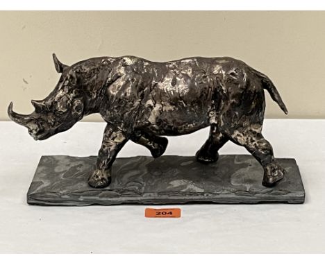 ROBERT RATTRAY. IRISH/WELSH CONTEMPORY&nbsp;A sterling silver sculpture of a rhinocerus. Signed and numbered 2/10, raised on 