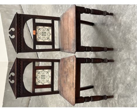 A pair of Victorian mahogany hall chairs, the backs with inset tile (One cracked)