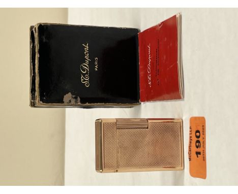 S.T. Dupont. An engine turned lighter, serial number 7706AR. Boxed with instruction leaflet C.1970. 2¼ high. Note: colour cod
