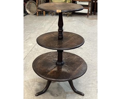 A Victorian three tier dumb waiter on tripod support. 40' high