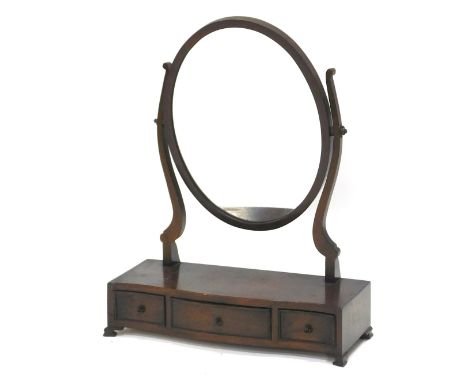 A mahogany dressing table mirror in George III style, with oval plate on shaped supports, the serpentine printed base with th