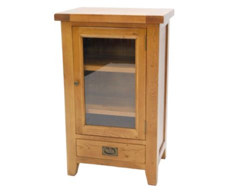 A modern light oak Hi-Fi cabinet, with single glazed door and a drawer, 106cm high, 64cm wide. 