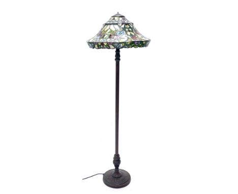 A bronzed metal standard lamp, with Tiffany style shade, decorated with leaded stained glass, flowers, etc. (AF), lacking fin