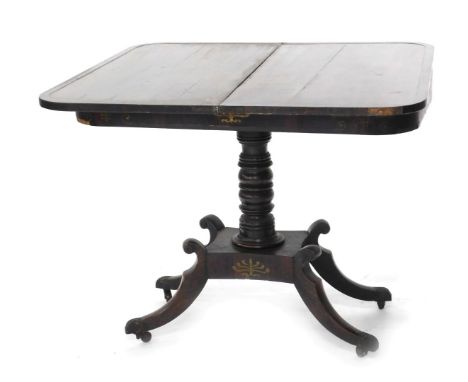 A Regency rosewood and brass inlaid card table, the rectangular top enclosing an interior lacking baize, above a frieze decor