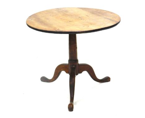 A George III oak occasional table, circular tilt top on a gun barrel turned column and tripod base, 81cm diameter.