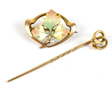 A 9ct yellow gold enamel and seed pearl brooch of open form with leaf&nbsp;decorated central panel (af), and a yellow metal e