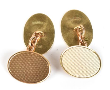 A pair of 9ct yellow cuff links, one section on each with engine turned decoration, approx 6.9g.Additional InformationGeneral