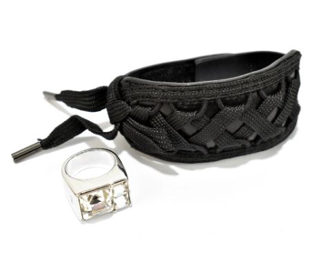 CHRISTIAN DIOR; a silver tone and large crystal ring, approx size M/N, and a Christian Dior black leather laced cuff, with du