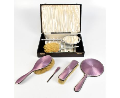 W G SOTHERS LTD; a George V hallmarked silver and lilac guilloché enamelled three piece dressing table set comprising mirror,