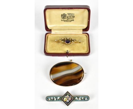 A 15ct yellow gold amethyst and seed pearl brooch, length 4.2cm, approx 3.g, a agate brooch in yellow metal frame, width 5cm,
