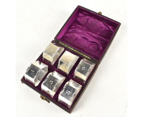 JAMES DIXON &amp; SONS; a cased set of six Edward VII hallmarked silver hexagonal napkin rings numbered 1-6 with further brig