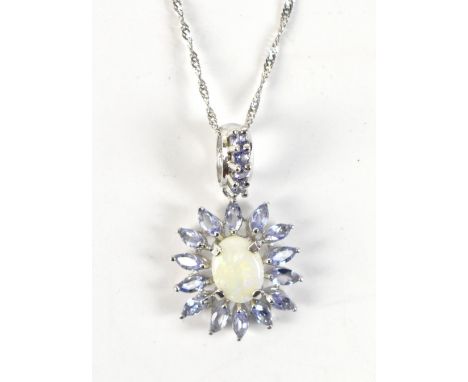 A white metal floral motif pendant set with tanzanite and opal, stamped 'Mexico 10k' to interior of bail, length 2.5cm, on 9c