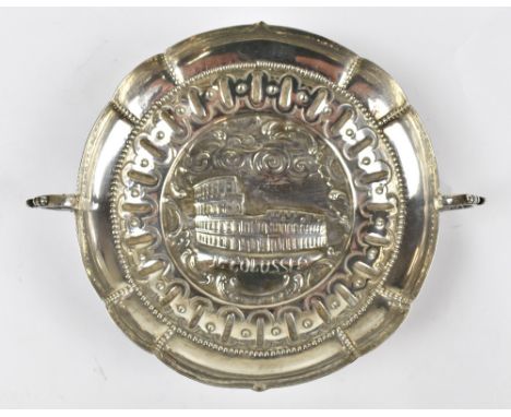 An Italian silver twin handled tastevin with repoussé decoration featuring the Roman Colosseum and inscribed 'Il Colosso' wit