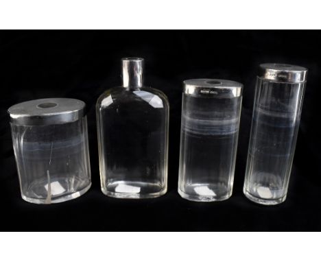 A set of four clear glass and silver mounted dressing table jars hallmarked for London 1944, height of tallest 13.8cm (4).Add