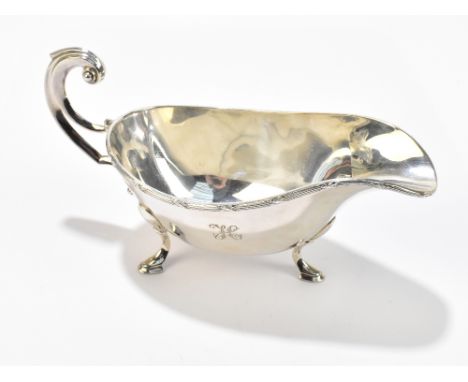 VINERS LTD; a George VI hallmarked silver sauceboat with cast rim, raised on three hoof feet, with engraved initial ‘H’ to bo