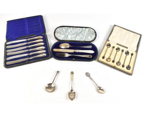 A group of variously hallmarked silver comprising a matched cased christening set, cased set of coffee spoons and silver hand