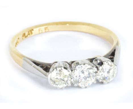 An 18ct yellow gold and diamond three stone graduated diamond ring, the central stone weighing approx 0.33ct, the side stones