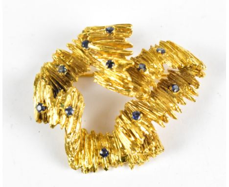 An 18ct yellow gold and saphhire textured brooch, with eleven applied sapphires, approx 22.7g.Additional InformationGeneral w
