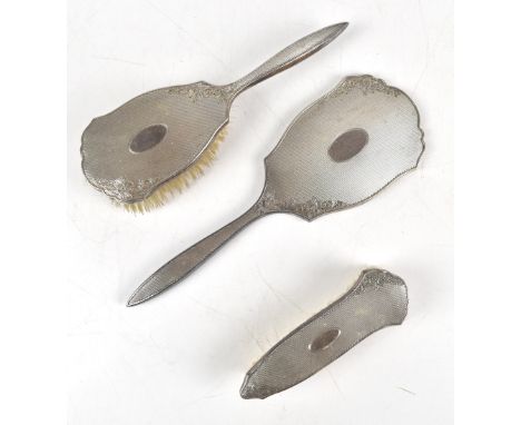 W I BROADWAY &amp; CO; an Elizabeth II hallmarked silver three piece dressing table set with engine turned decoration surroun