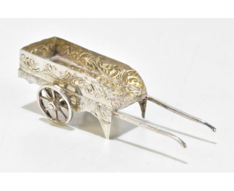 SAMUEL BOAZ LANDECK; an Edward VII hallmarked import silver model of a wheelbarrow with repousse decoration featuring a court