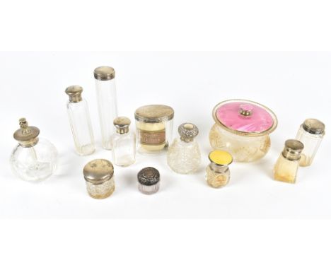Ten assorted dressing table bottles with hallmarked silver tops and collars, one example with guilloche enamel decoration, a 