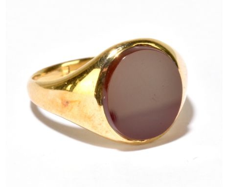 A yellow metal and polished hardstone signet ring, hallmark rubbed, size R 1/2, approx 6.8g.Additional InformationThe hallmar