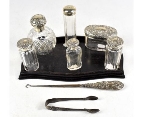 Six Victorian and later silver topped dressing table bottles including a bulbous example, London 1895, together with a matche