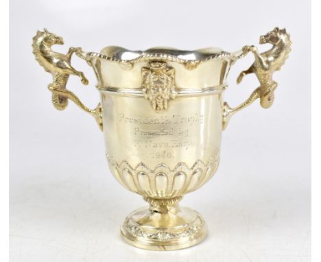 REID & SON; a George V hallmarked silver twin handled pedestal trophy cup with cast hippocampus handles and engraved inscript