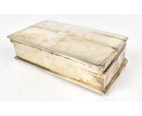 A hallmarked silver cigarette box of rectangular form, with engine turned detail surrounding a rectangular vacant cartouche, 