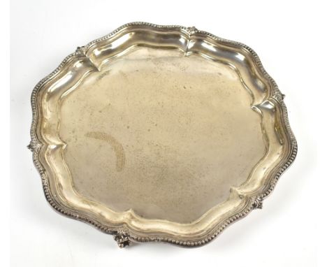 WALKER &amp; HALL; a George V hallmarked silver salver raised on three scrolling supports inscribed 'Presented to Eric Ransom