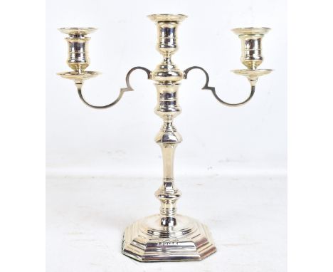 An Elizabeth II hallmarked silver triple sconce candelabrum, the sconces detachable to form a single candle stick, the base s