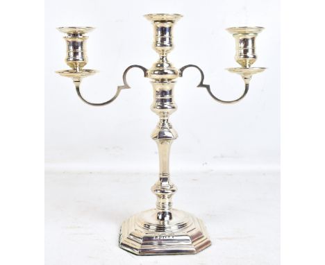 An Elizabeth II hallmarked silver triple sconce candelabrum, the sconces detachable to form a single candle stick, the base s