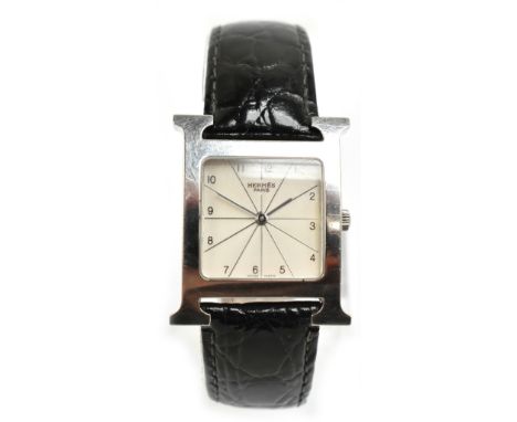 HERMÈS; a quartz stainless steel wristwatch, the rounded square dial set with Arabic numerals within the H logo case, no.HH1.
