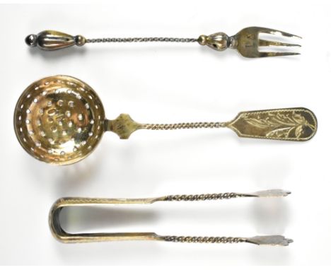An early 20th century cased set of Russian 84 zolotnik silver sugar strainer, length 14cm, pair of sugar tongs and fork, the 