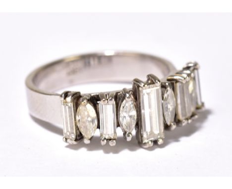 A white metal and diamond ring with five rectangular cut diamonds and four marquise cut diamonds in four claw settings, unmar