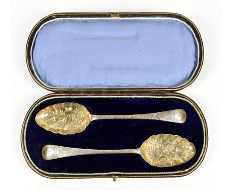WALKER & HALL; two Victorian hallmarked silver berry spoons with gilt bowls and chased decoration to the handles, with engrav
