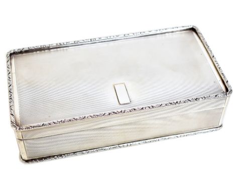 ASPREY; a George VI hallmarked silver trinket box of rounded rectangular form with engine turned decoration and floral detail