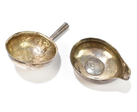 Two 18th century white metal toddy ladle bowls, one with George II shilling, approx 1.5ozt/48g (af) (2).Additional Informatio