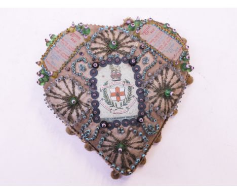 A Victorian sweetheart pin cushion bearing Lancashire Regiment badge, length 20cm. Condition - general wear.