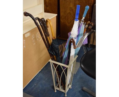 A Wrought Iron Stick Stand Containing Various Walking Sticks and Umbrellas 