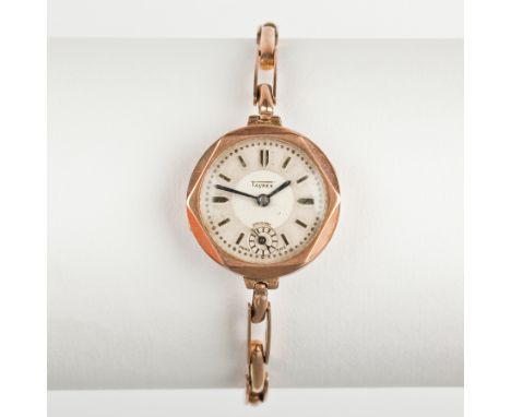 LADY'S NINE CARAT GOLD TAUREX WRIST WATCH
the dial with baton numerals and subsidiary seconds, hallmarked to inner case, on a