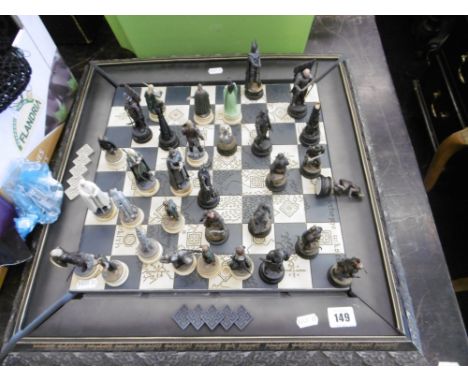 A LORD OF THE RINGS CHESS SET WITH CAST METAL CHESS PIECES