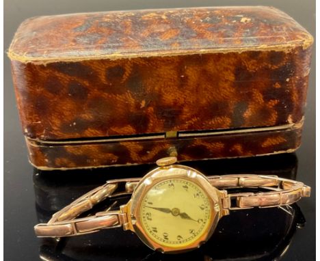 A lady's 9ct rose gold watch, white enamel dial, Arabic numerals, integral 9ct rose gold expanding bracelet strap, 15.7g gros