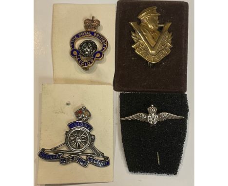 A Churchill Victory badge; an enamel Royal Artillery badge; an RAF pin; a British Legion badge (4) 