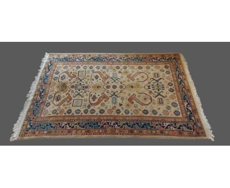 A North West Persian woollen rug with an all over design within multiple boarders upon a cream and terracotta ground, 156cms 