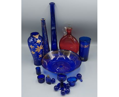 A collection of blue glass to include two eye glass and three vases together with a Cranberry glass decanter and a bowl 
