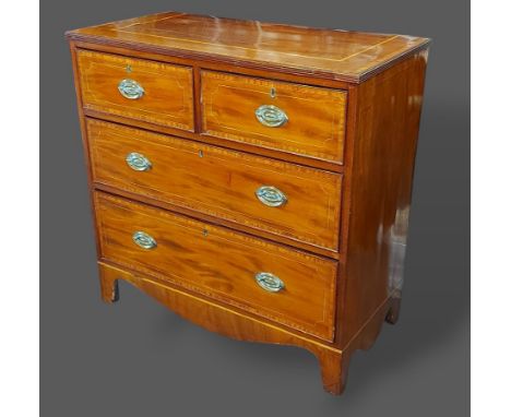 A 19th Century mahogany and satinwood inlaid straight front chest, the reeded top above two short and two long drawers raised