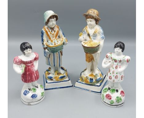 A pair of 19th Century Prattware figures, market sellers, 18cms tall together with a pair of smaller Pearlware figures